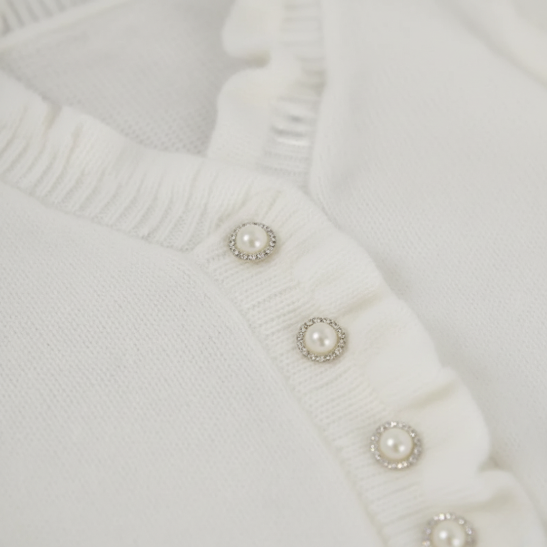 Maglione bianco da donna con volant e perle